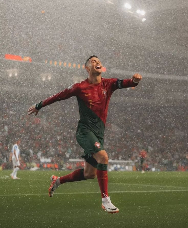 Cristiano Ronaldo celebrating in heavy rain for Portugal on the night he reached 900 career goals